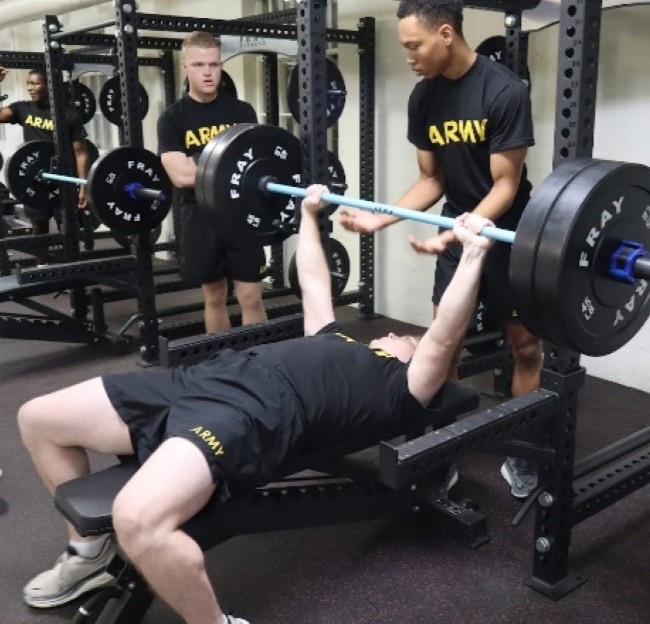 cadets working out with weight equipment in a gym