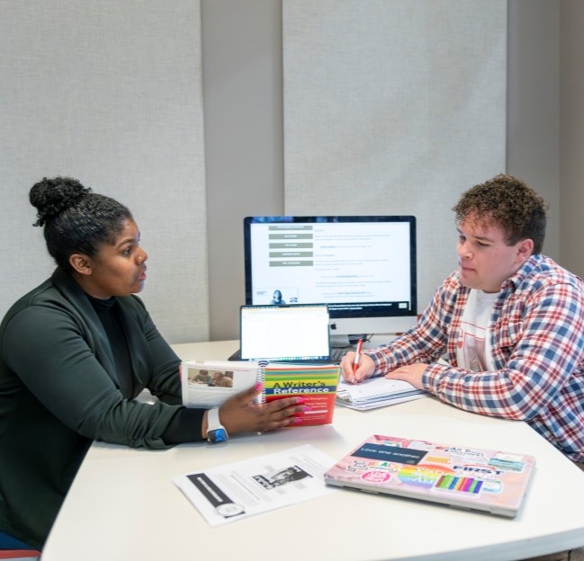image of staff and student working together at a table