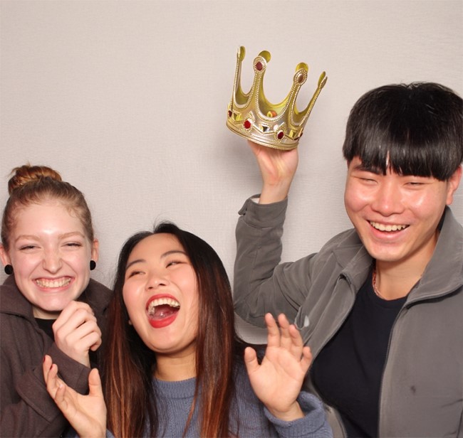 image of three students laughing together in a photo booth