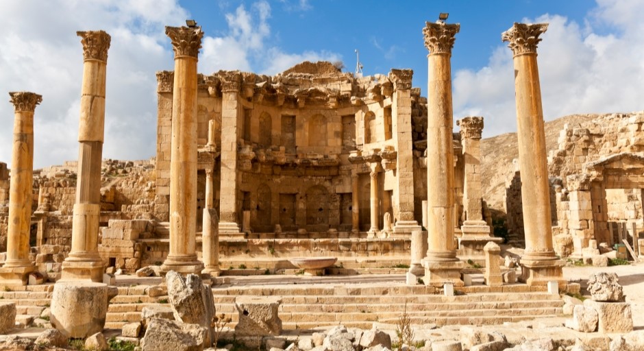 ancient Roman ruins in the desert with columns and a building facade