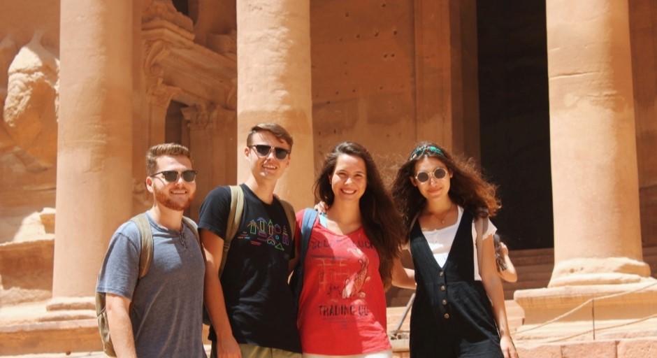 students standing together with Petra site behind them