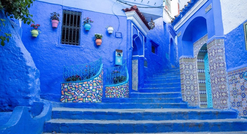 blue painted walls of the alleyway and walls of a town in Morocco