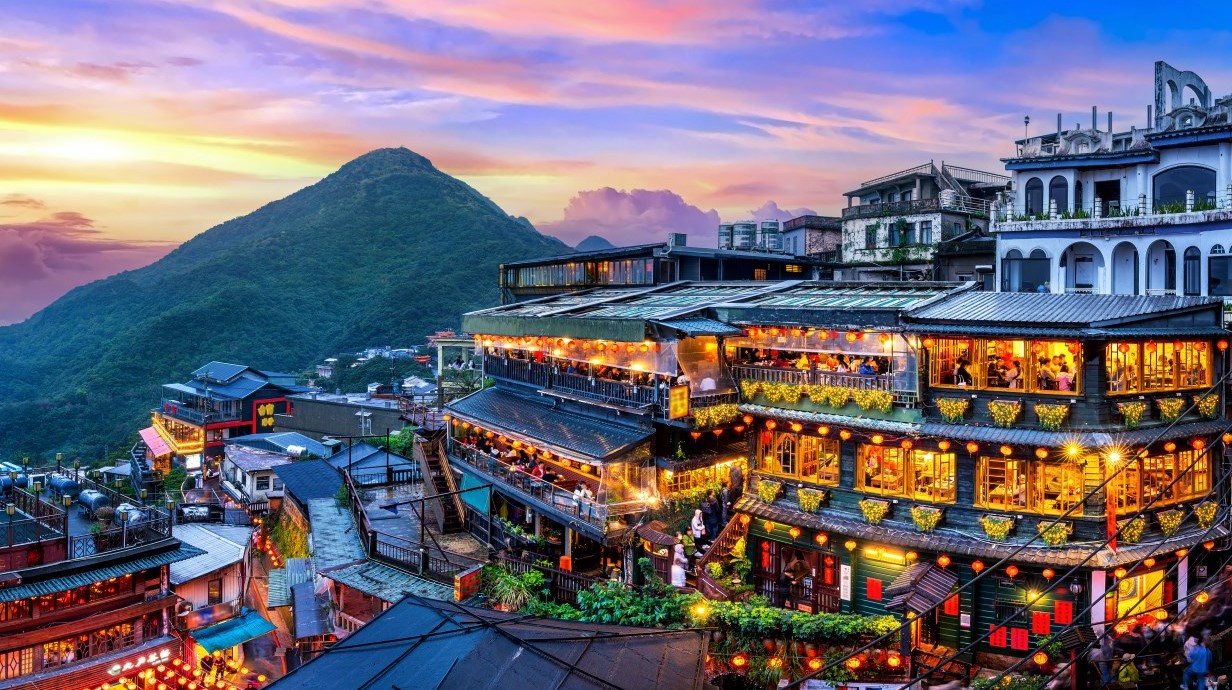 image of traditional architecture of an old town buildings with mountains in the background