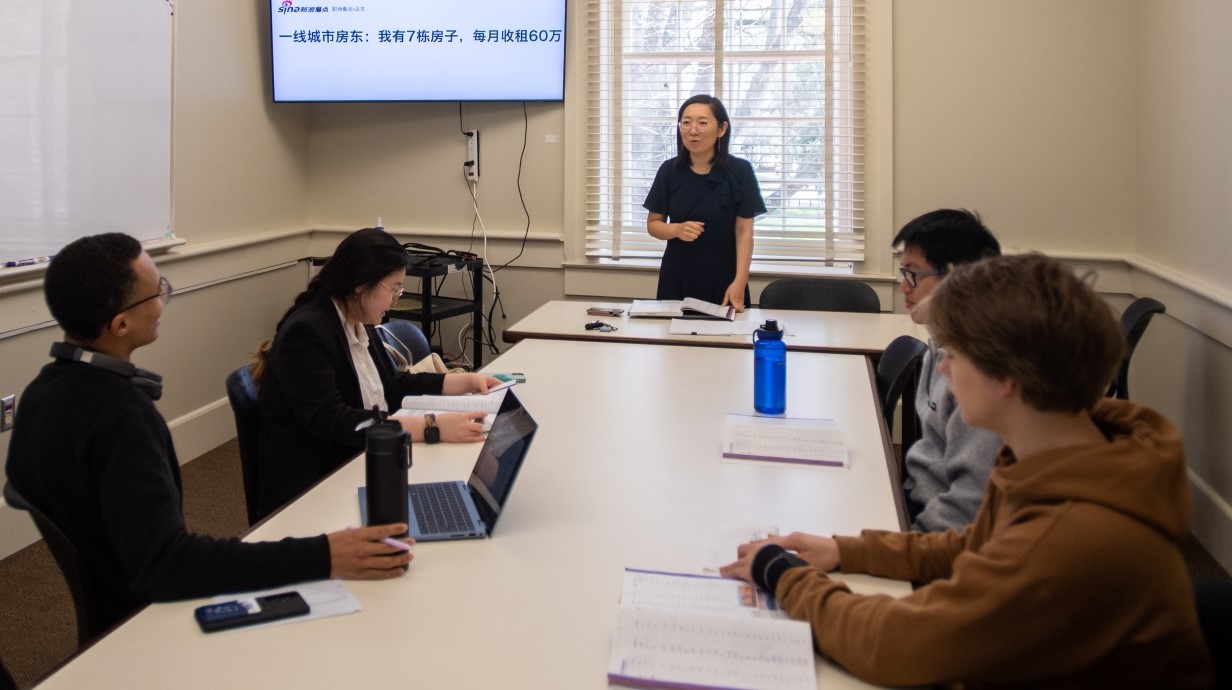 image of a few students seated around a table in a Chinese language class