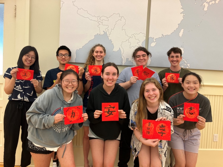 image of a group of students holding up calligraphy