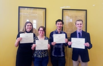 image of a small group of students standing and holding certificates