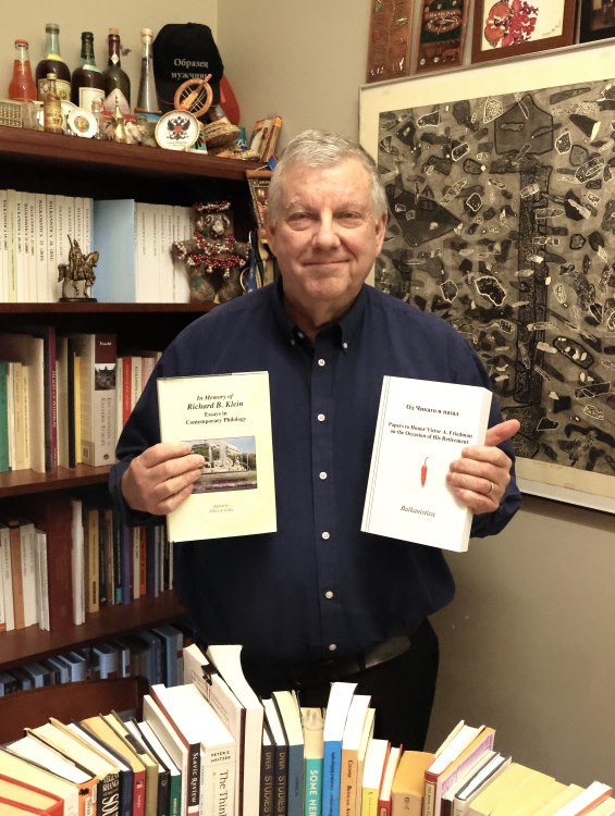 image of Don Dyer in his office holding the two journals