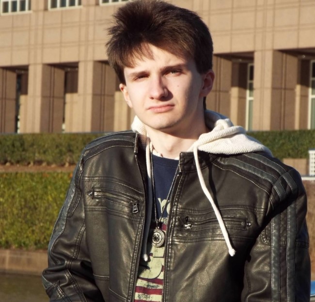 image of Tyden Kortman standing outside with a building behind him