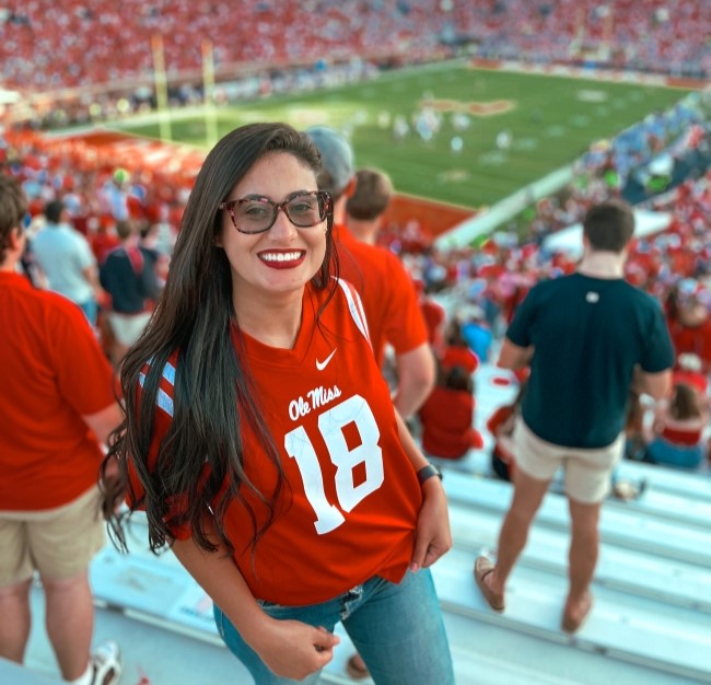 international student standing in the football field