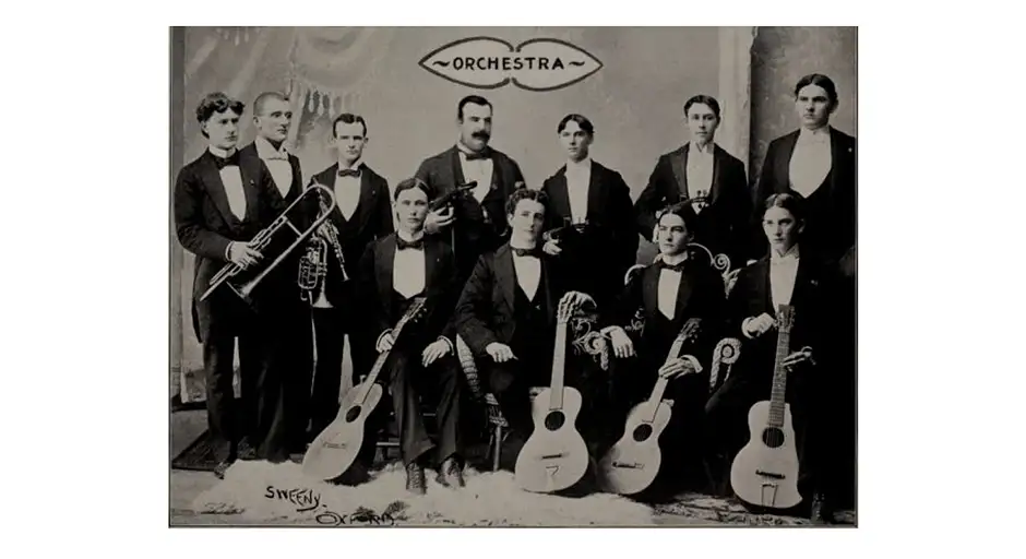 Archival black and white photo of group of musicians with their instruments.