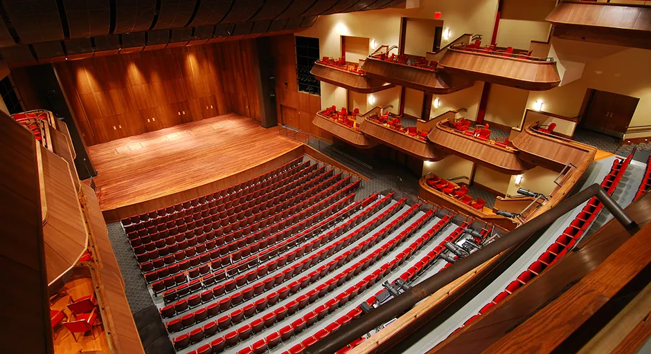Bird's eye view of performance hall interior with view of seats and stage.