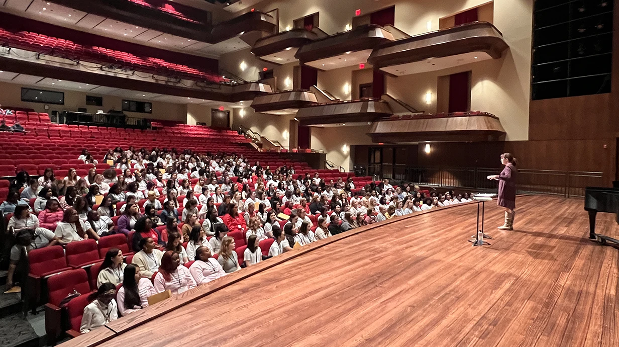Choir Festival clinician speaks to treble festival participants from the Ford Center stage.