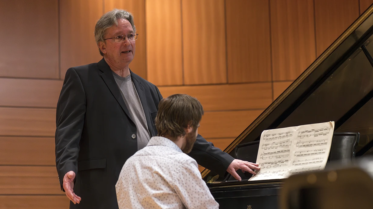 Dr. Ian Hominick mentors a piano student