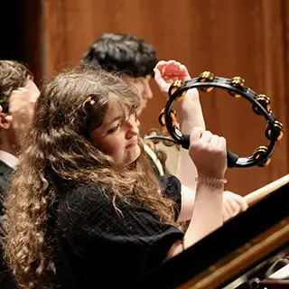 Band member plays tambourine