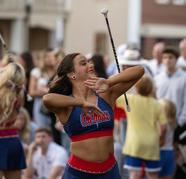 A Feature Twirler balances the baton on her elbow during a pep-rally performance on the Oxford Square