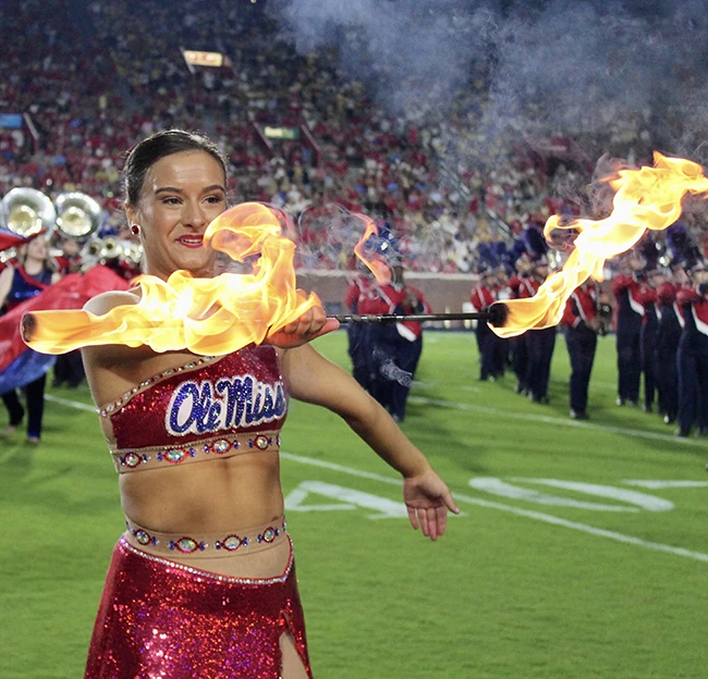 A Feature Twirler balances the baton on her elbow during a pep-rally performance on the Oxford Square