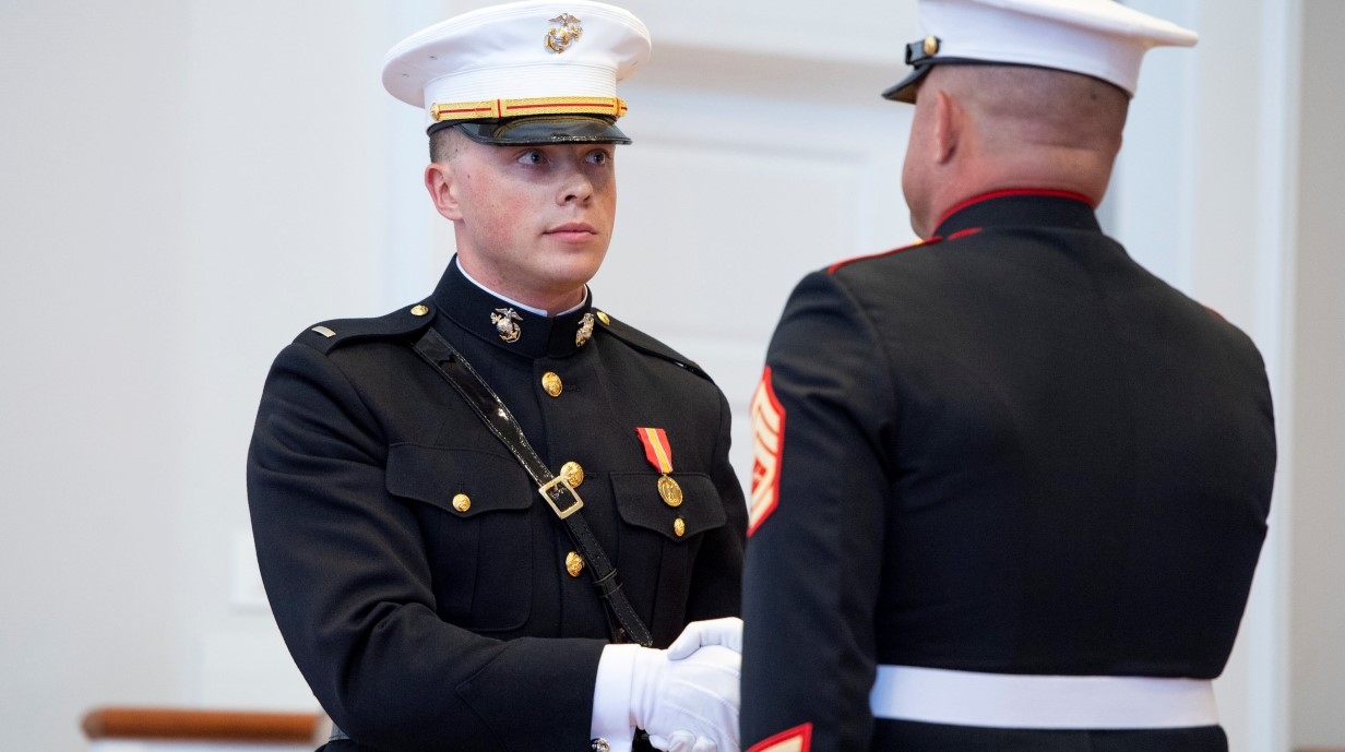 image of two cadets shaking hands while in dress uniform