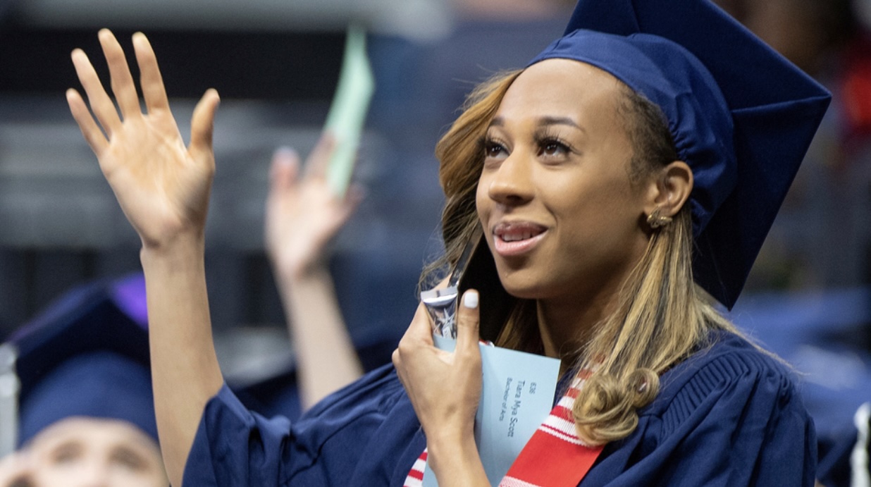 Graduating student in commencement garb.