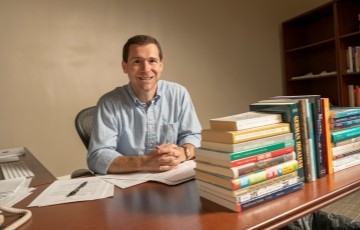 image of faculty member sitting in his office