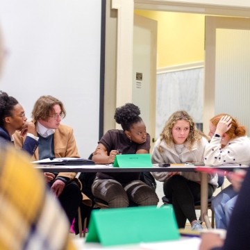 image of students conferring together during an ethics debate