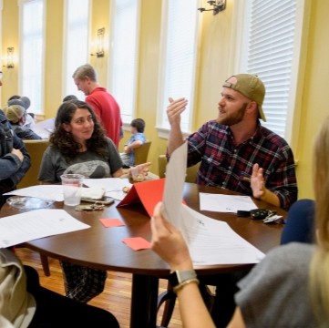 students seated together at a table talking