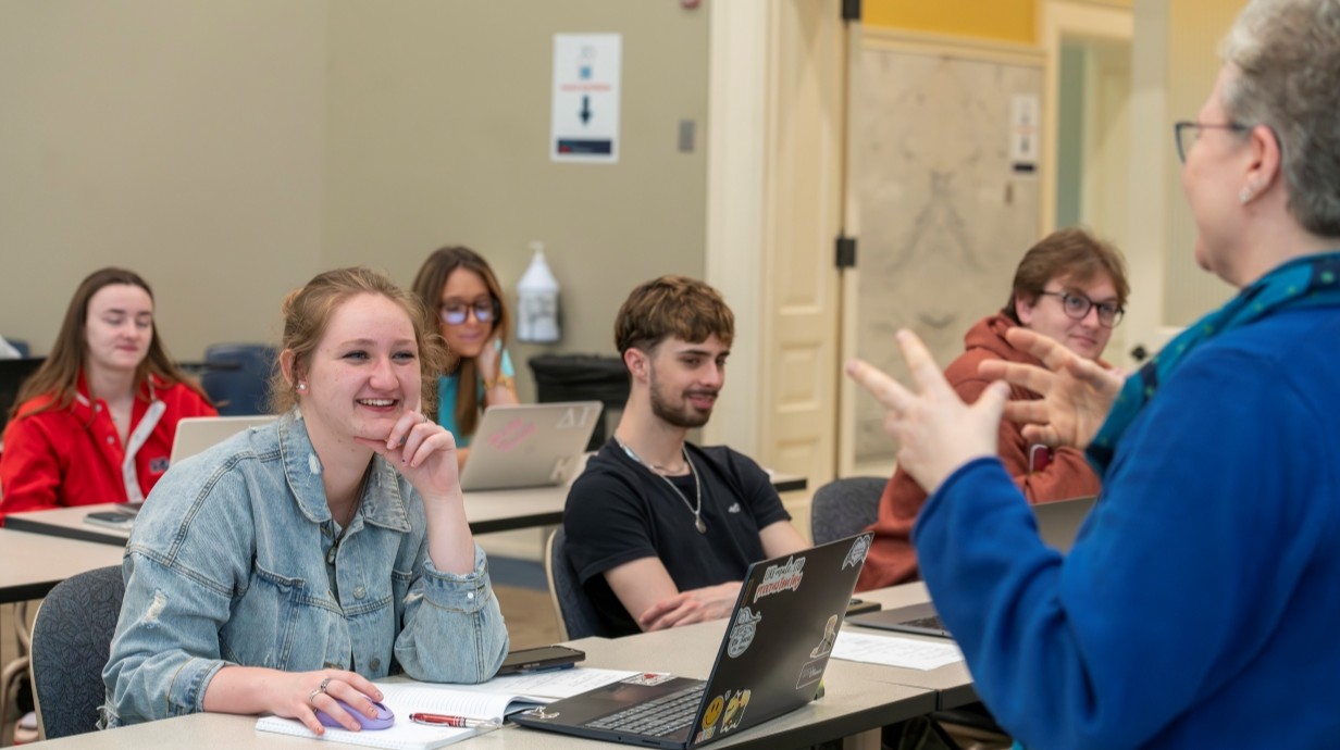 Professor talks in front of the class.