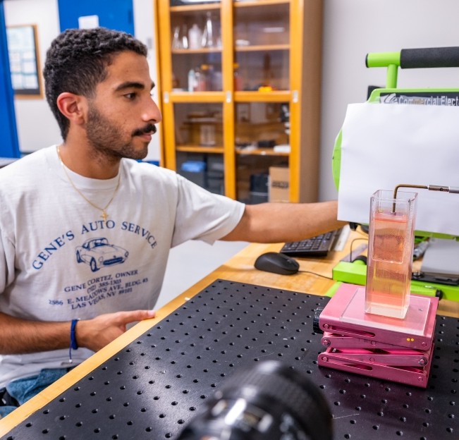 student working with an experiment with a special table top equipment
