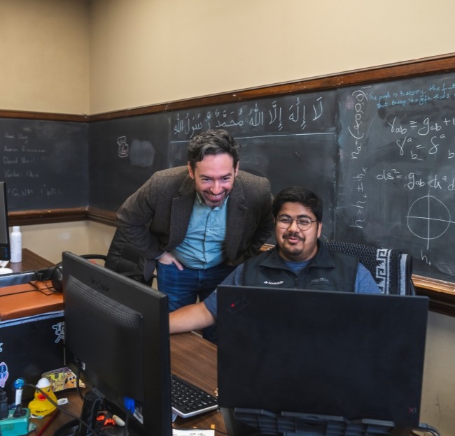 image of Leo Stein working with a graduate student at his computer