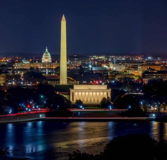 image of Washington DC at night with major monuments lit up