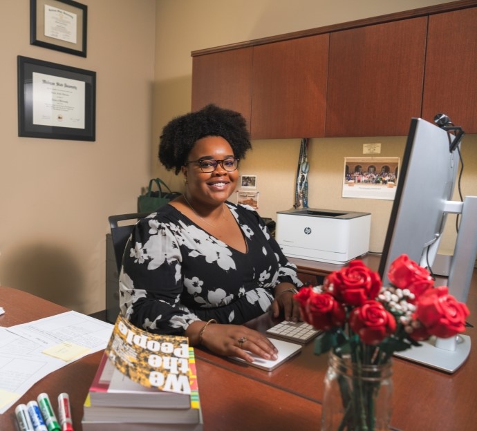 image of Kesicia Dickinson seated at her desk 