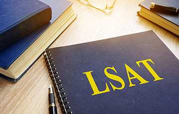 blue notebook with LSAT text on it in yellow writing