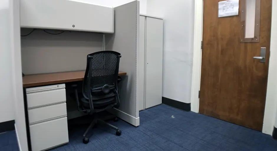 desk, office chair, gray storage cabinets, and blue carpet 