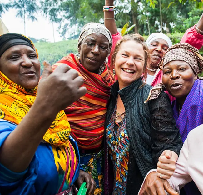 Smiling group of women looking at camera in colorful clothing and headscarfs