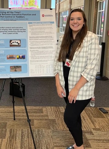 image of Racheal Embry standing next to research poster