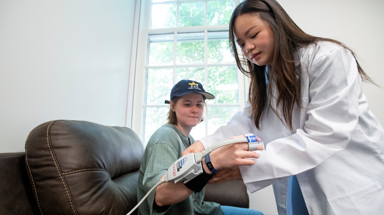 Image of a student being strapped up in a research lab
