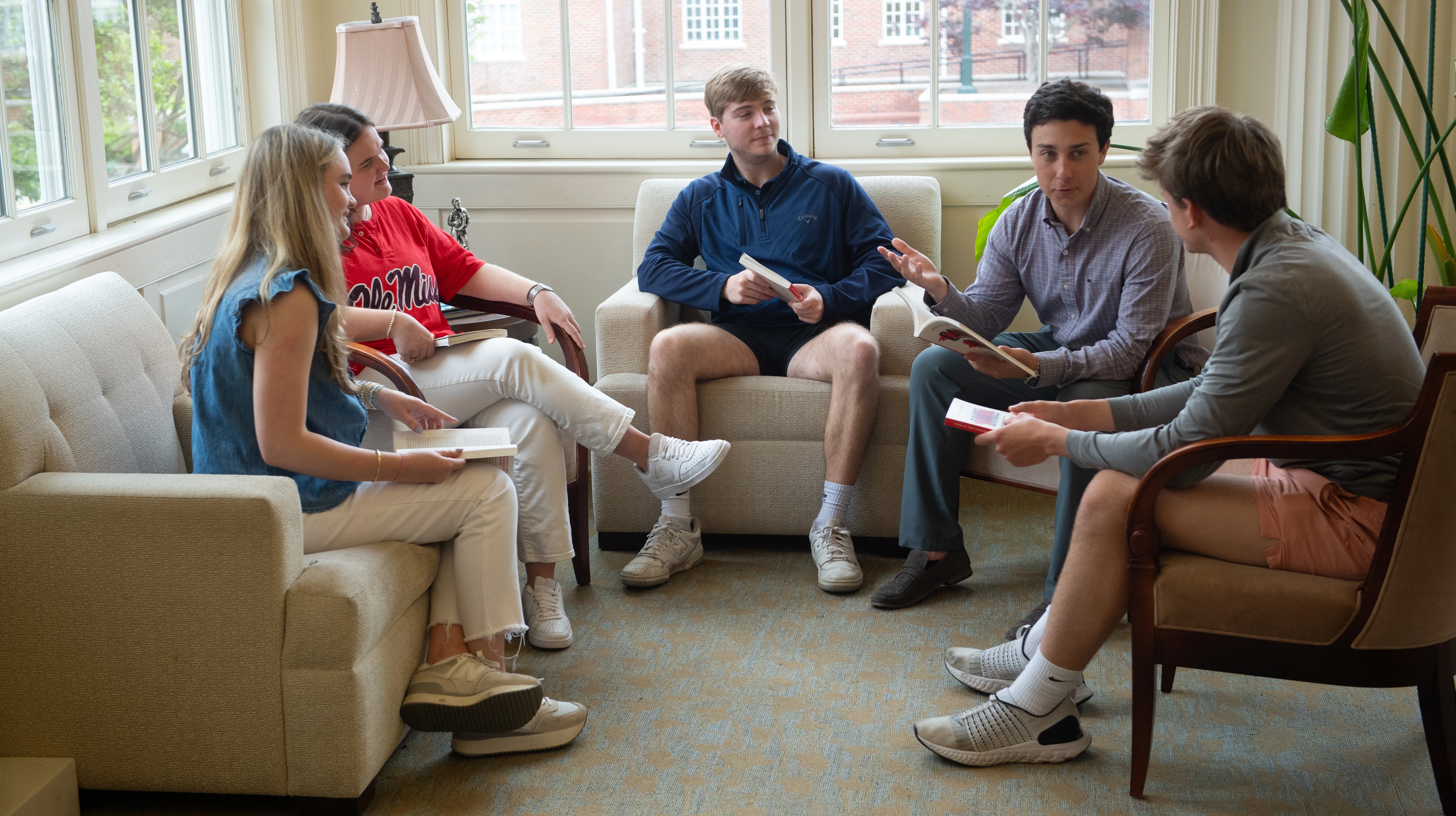 Five students discussing a lecture