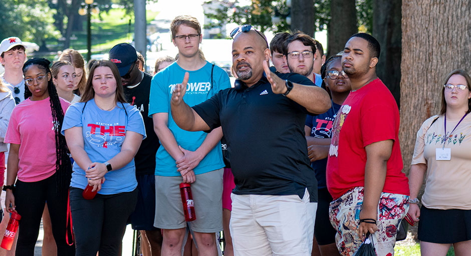 man giving a tour of campus to people