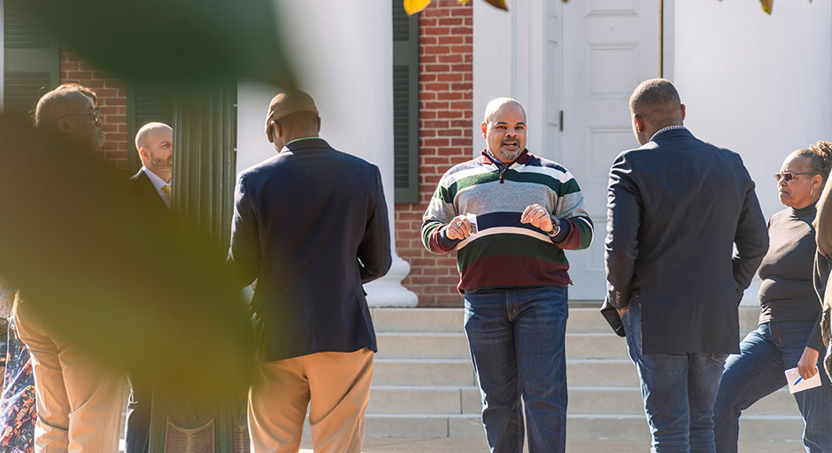 man giving a tour of campus to people