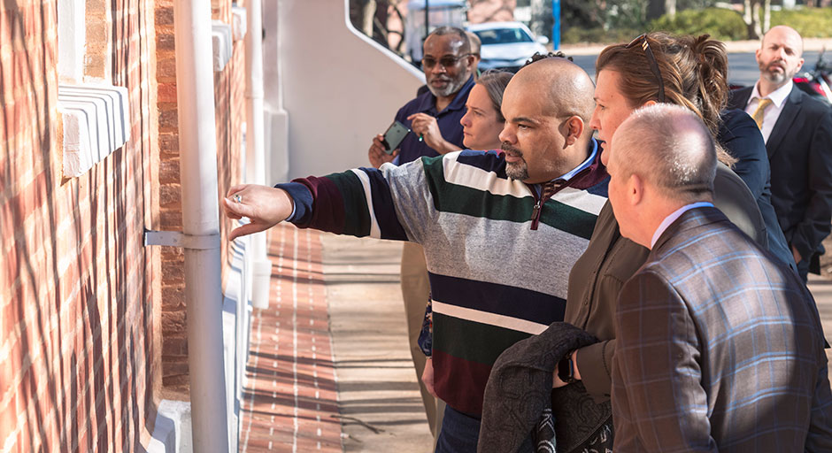 man giving a tour of campus to people