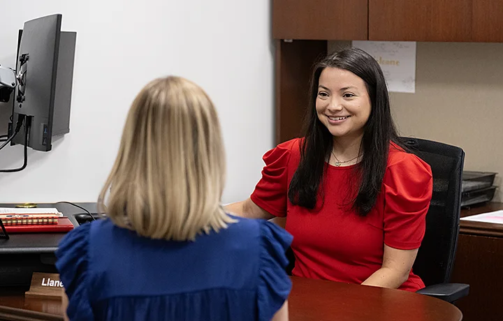 image of staff member and student talking in an office