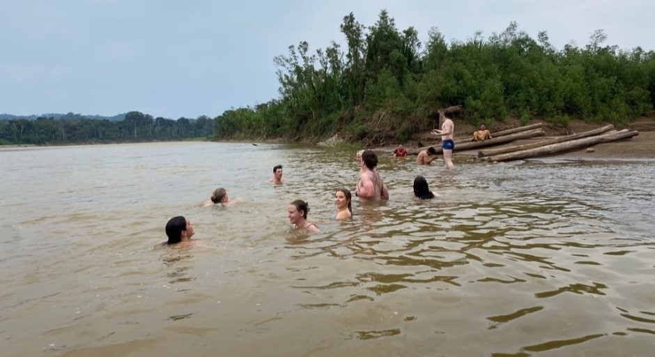 students swimming in the river