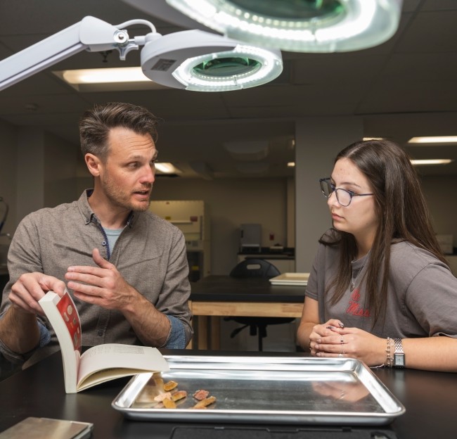 student working with faculty in research lab