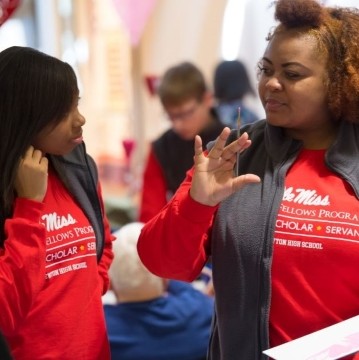 image of a few young people talking with a staff person