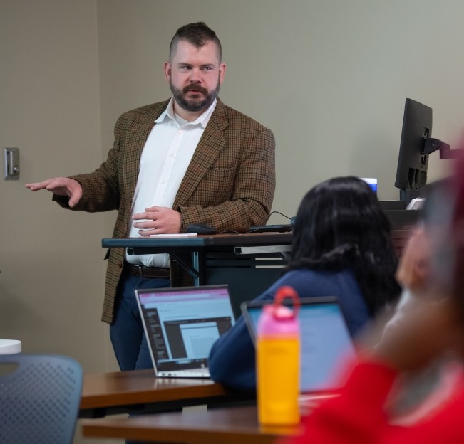 image of Ryan Parsons teaching in front of the classroom