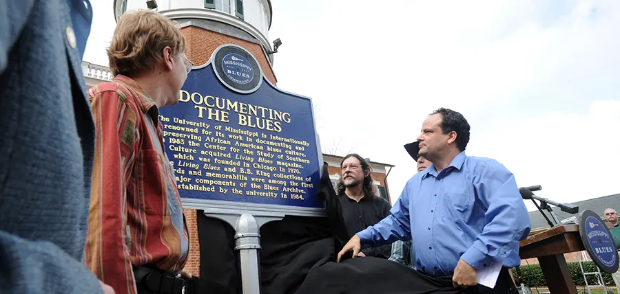 Mark Camarigg, publications manager of Living Blues magazine, Jim O'Neal, co-founder of Living Blues, Brett Bonner, Living Blues editor, and Scott Barretta, Highway 61 Radio host unveil the Blues Marker honoring Living Blues magazine which is published at The University of Mississippi.