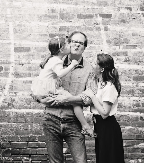 black and white photo of Peter Askew with his wife and daughter