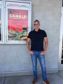 rex jones standing in front of movie poster