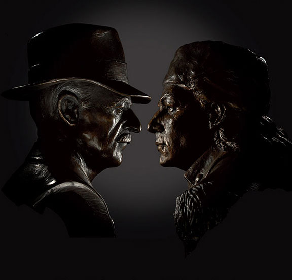 two model heads facing each other on black background