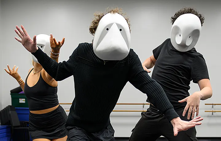 3 people dancing with masks on