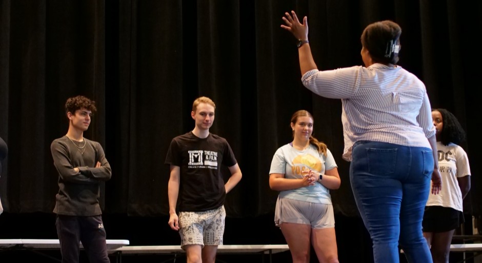 acting coach on the stage with students for a lesson